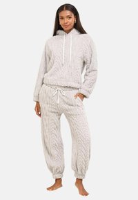 Set di loungewear grigio a maglia con un hoodie cropped dotato di lacci e pantaloni con vita elasticizzata, polsini e tasche laterali.