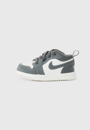 Gray and white toddler sneaker with a round toe, textured leather upper, laces, and a pull tab at the heel; rubber outsole.