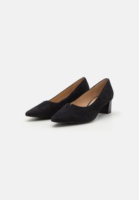 Black suede block-heeled pumps with a pointed toe and a small cutout detail at the vamp. Smooth texture and clean design.