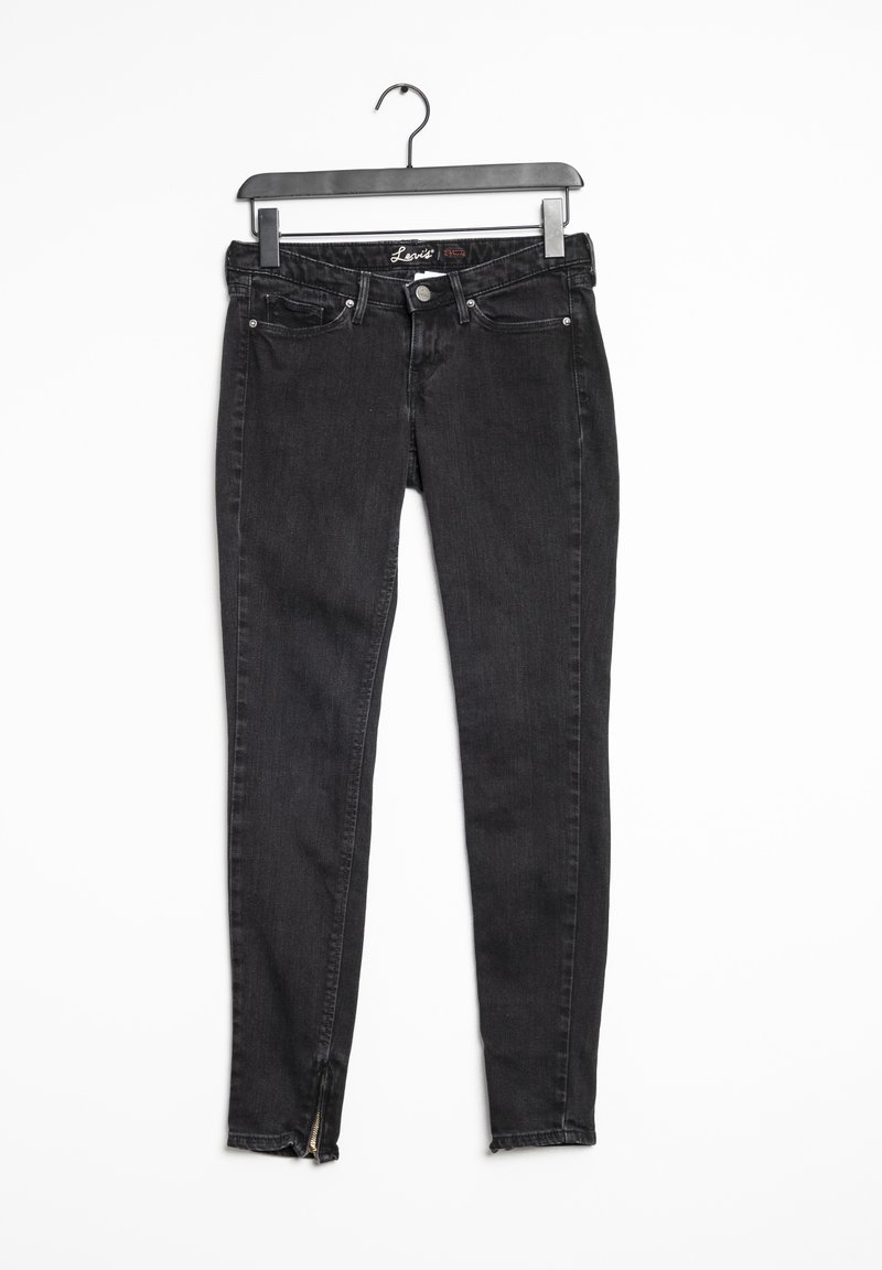 Jean skinny noir en denim, avec une taille mi-haute, cinq poches, un léger délavage et des zip aux chevilles pour la touche de détail.