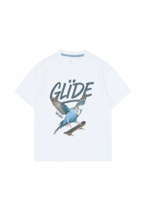 T-shirt blanc avec un dessin d’un oiseau bleu sur un skateboard et le mot « GLIDE » en grandes lettres grasses au-dessus.