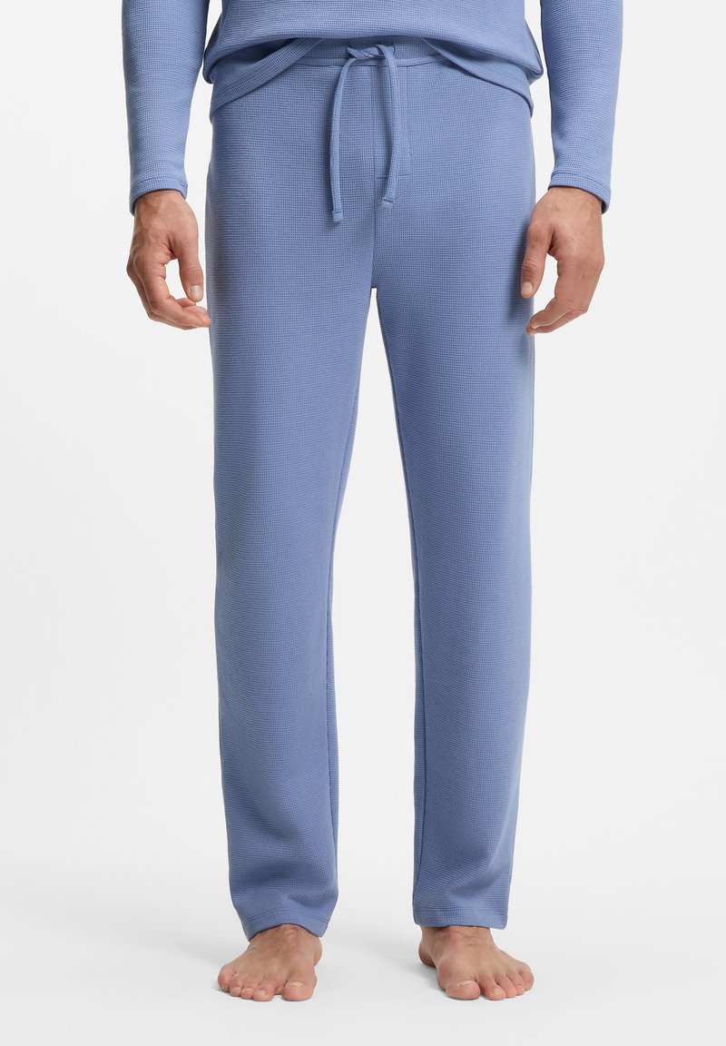 Lichtblauwe loungebroek met een wafelstructuur en een taille met trekkoord. Rechte pijpen en een zachte structuur. Geen zichtbare patronen of accenten.