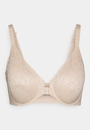Beige lace bra with molded cups, adjustable straps, and a front closure. The fabric features a floral pattern and smooth textured backing.