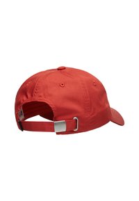 Red baseball cap made of cotton with a curved visor, adjustable fabric strap, and a metallic buckle at the back. Smooth texture.