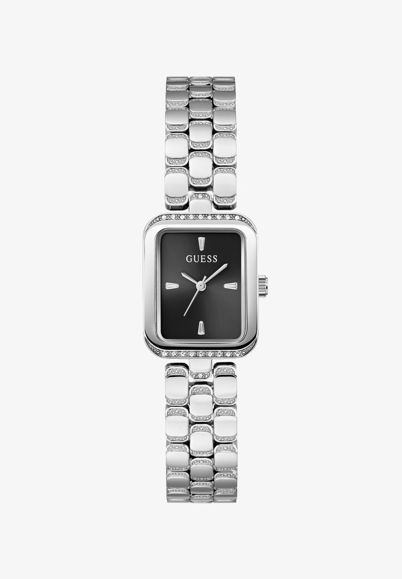 Montre bracelet en métal argenté avec cadran carré noir, index argentés et logo Guess sous 12 heures.