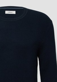 Granatowy sweter z prążkowanej dzianiny z okrągłym dekoltem. Posiada teksturowane poziome paski oraz metkę z napisem "s.Oliver" przy dekolcie.