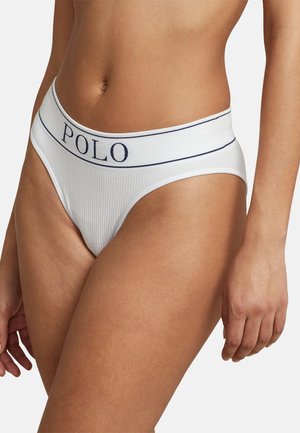 White ribbed brief with a blue "POLO" waistband. Features a high-cut design and smooth texture, emphasizing comfort and fit.