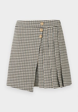 Καρό φούστα σε ασπρόμαυρο με τρία χρυσά κουμπιά, με πιετέ σχεδιασμό και μπροστινή σχισμή. Μαλακή υφή υφάσματος.