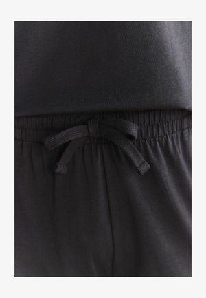 Pantaloni negri din bumbac cu șnur, având talie elastică, cu un detaliu texturat la față și un finisaj de material neted și moale.