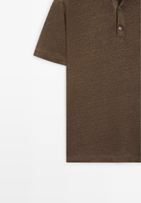 Brown short-sleeve polo shirt with a two-button placket and soft, textured fabric shown against a white background.