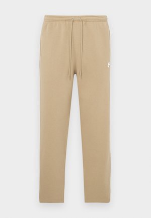 Pantaloni della tuta beige con vita elasticizzata e coulisse, con piccolo logo Nike bianco sulla parte superiore della coscia sinistra.