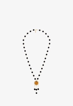 Necklace featuring black beads linked by gold chain, with a large amber pendant and dangling beads. Simple round design with a smooth texture.