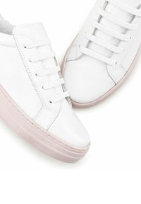 Weiße Ledersneaker mit strukturierten Gummisohlen, die einen hellrosa Akzent und weiße Schnürsenkel haben und ein minimalistisches Design präsentieren.