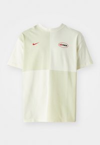 Kerge kreemjas värvis puuvillane T-särk, millel on laia lõikega vorm. Esiküljel on Punane Nike logo ja "aimax" graafika, sile tekstuur.