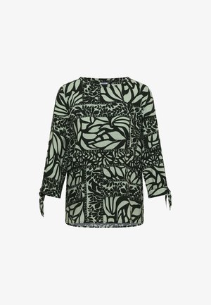 Blouse à manches longues avec motif abstrait de feuilles noires et vert clair et chaîne, avec poignets noués sur chaque manche.
