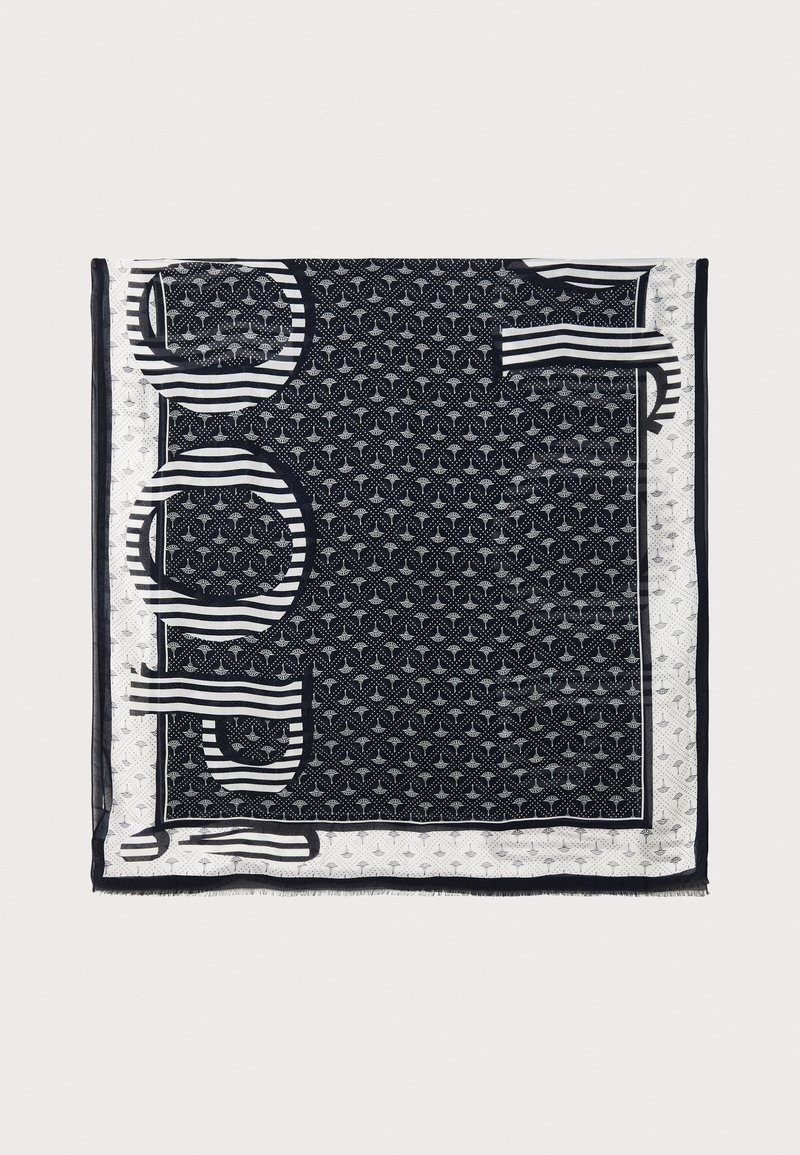 Foulard quadrato bianco e nero con motivi geometrici, strisce e bordi frangiati. Realizzato in tessuto leggero e trasparente.