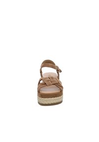 Brown suede platform sandal with woven jute sole, crisscross straps, adjustable ankle strap, and closed back. Flat sole with a slight heel.
