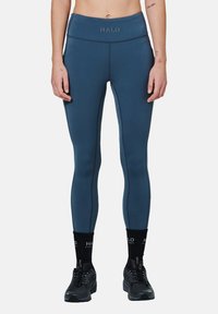 Hoge taille leggings in donkerblauw met contrasterende naden. Zachte stof, slanke pasvorm en een HALO-logo op de tailleband. Geschikt voor sportswear.