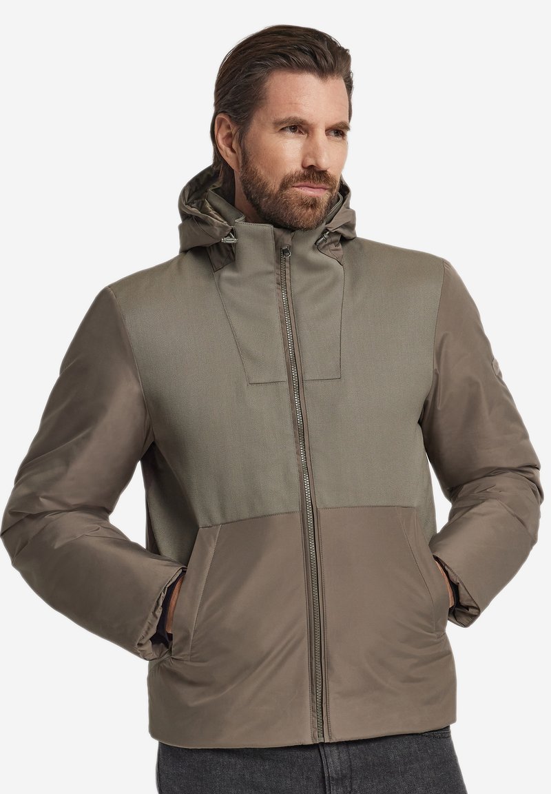 Kapuzenjacke in Olivgrün mit einer Mischung aus strukturierten und glatten Einsätzen. Verfügt über einen Frontreißverschluss und zwei seitliche Taschen.
