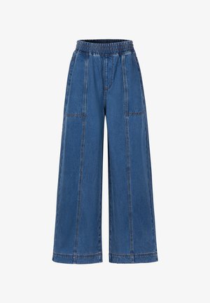 Weite blaue Denim-Hosen mit elastischem Bund und sichtbaren vertikalen sowie horizontalen Nahtdetails auf der Vorderseite.