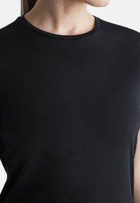 Black crew-neck t-shirt, made of smooth fabric, featuring short sleeves and a fitted design. No visible patterns or hardware details.