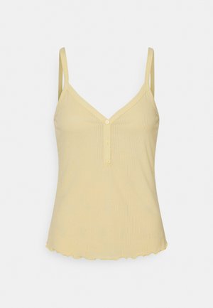 Lysegul ribbet tanktop med V-hals, knaplukning og skåreskåret kant. Tynde justerbare stropper og blød tekstur.