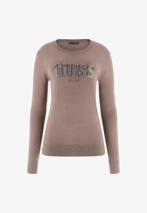 Maglione marrone con maniche lunghe, colletto e orlo a coste, con logo "GUESS" impreziosito da strass e "EST. 1981" in carattere più piccolo sottostante.