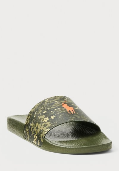 Green slide sandal with a textured sole and a wide strap featuring a floral pattern and an orange logo. Smooth and lightweight design.