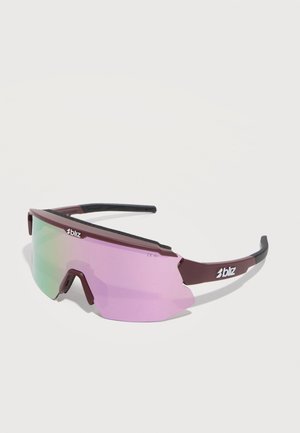 Lunettes de sport enveloppantes avec des verres irisés violet-vert et une monture marron avec le logo « bliz » sur les côtés.