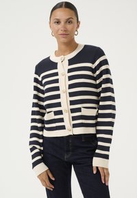 Navy and cream striped cardigan with a round neckline, button front, and two pockets. Features ribbed cuffs and hem in a soft knit texture.