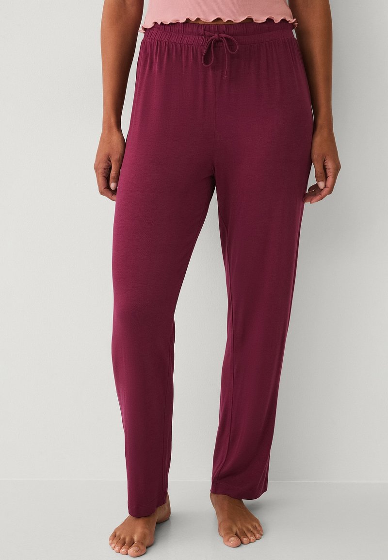 Burgundy pajama pants made of soft, lightweight fabric with an elastic waistband and drawstring. Features a straight leg design.