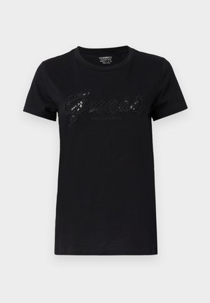Sort t-shirt med korte ærmer, med et skinnende "Guess" logo i skrifttype og "Los Angeles" nedenunder, lavet af blødt bomuldsstof.