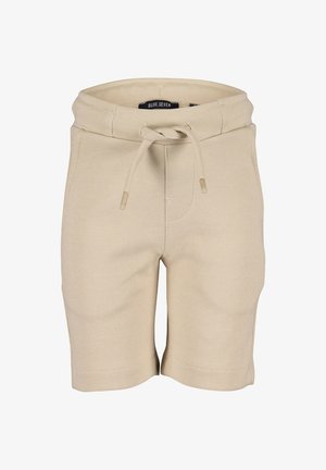 Shorts en tissu texturé beige avec une taille élastique et un cordon de serrage, des poches avant, et une étiquette de marque à l'intérieur de la taille.