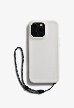 Smartphone with white protective case and black wrist strap attached, showing rear triple camera and flash module.