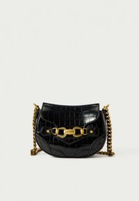 Black croc-embossed leather crossbody bag with gold chain strap and gold clasp engraved with "Just Cavalli" brand name.