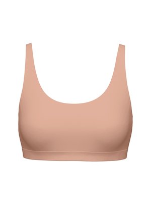 Seamless, light beige sports bra with wide straps and a scoop neckline, designed for comfort and support.