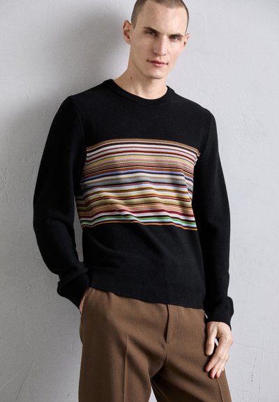Black knit sweater featuring a horizontal multicolored striped pattern across the chest. The design includes a round neckline and ribbed cuffs.