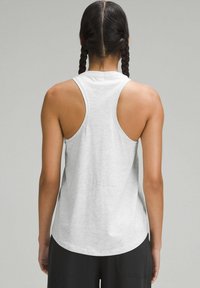 Light grey athletic tank top with a racerback design, rounded hem, and soft texture. Shows no visible logos or patterns.