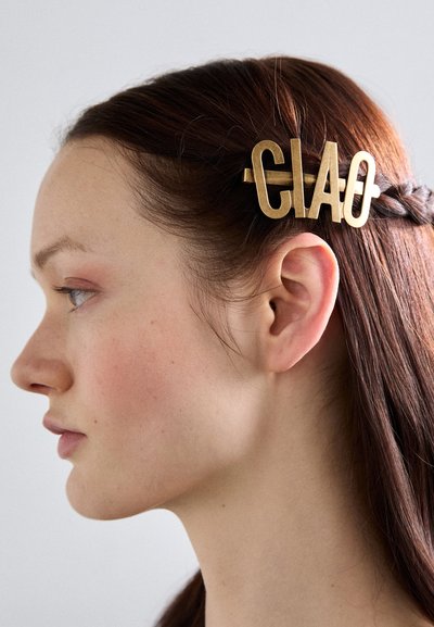 Brass hair clip with the word "CIAO," featuring a bold, modern design and a shiny, smooth finish. Secures hair neatly in place.