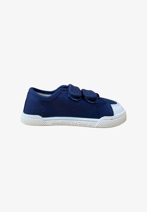 Zapatilla de lona azul marino con doble tira de velcro, puntera y suela de goma blanca, agarre de goma texturizado y logotipo en el lateral.