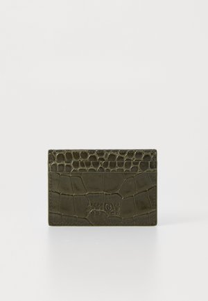 Dark green crocodile-embossed leather cardholder with embossed numeric branding on the front against a white background.