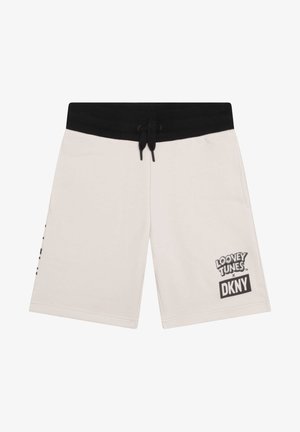 Pantalones cortos beige con cintura elástica negra y cordón, con el logo "Looney Tunes x DKNY" en la pierna derecha.