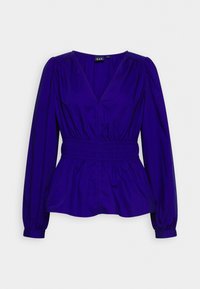 Top peplum viola con maniche lunghe a sbuffo, scollatura a V e vita elastica. Tessuto morbido, colore uniforme e dettagli arricciati sulle spalle.
