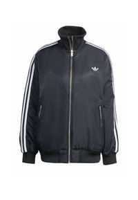 Veste zippée noire en tissu brillant, dotée de rayures verticales blanches sur les manches, de poignets côtelés, d'un col montant et d'un petit logo sur la poitrine.