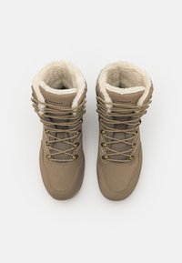 Brown hiking boots feature a soft faux fur lining, mesh inserts, and metallic eyelets with laces, designed for outdoor use.