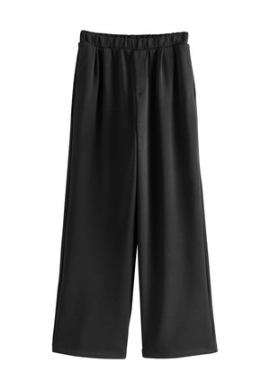 Pantaloni neri a gamba larga realizzati in materiale morbido, con vita elasticizzata e pieghe profonde per maggiore volume e comfort.