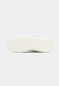 White rubber shoe sole featuring textured patterns and embossed "R" logo. Smooth edges with a slight curve at the toe end.