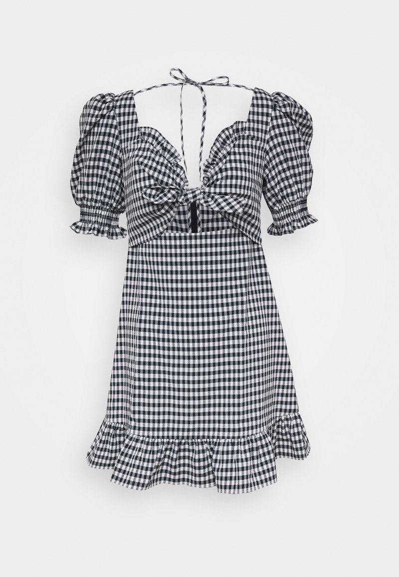 Robe mini en vichy noir et blanc avec manches bouffantes, nœud à l'avant, encolure carrée et ourlet à volants.