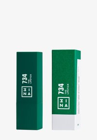 Grønn leppestift tube og eske, matt finish, firkantet form, merket "734 THE LIPSTICK" i hvit skrift, minimalistisk design.