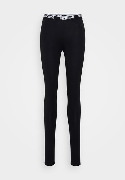 Leggings pretos slim-fit com uma faixa elástica branca com a marca "Moschino" em preto e um logótipo subtil no quadril.